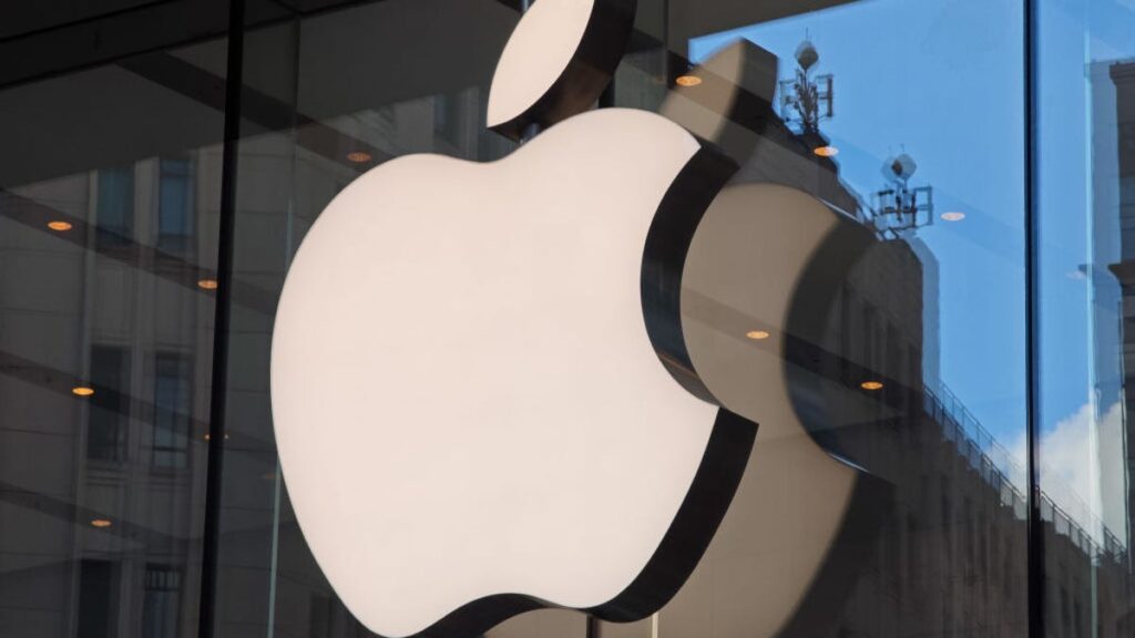 The Apple logo on a glass storefront.