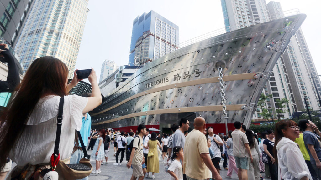 Tourists visit the world's only giant wheel-shaped building of French luxury giant Louis Vuitton (LV) in Shanghai, China.