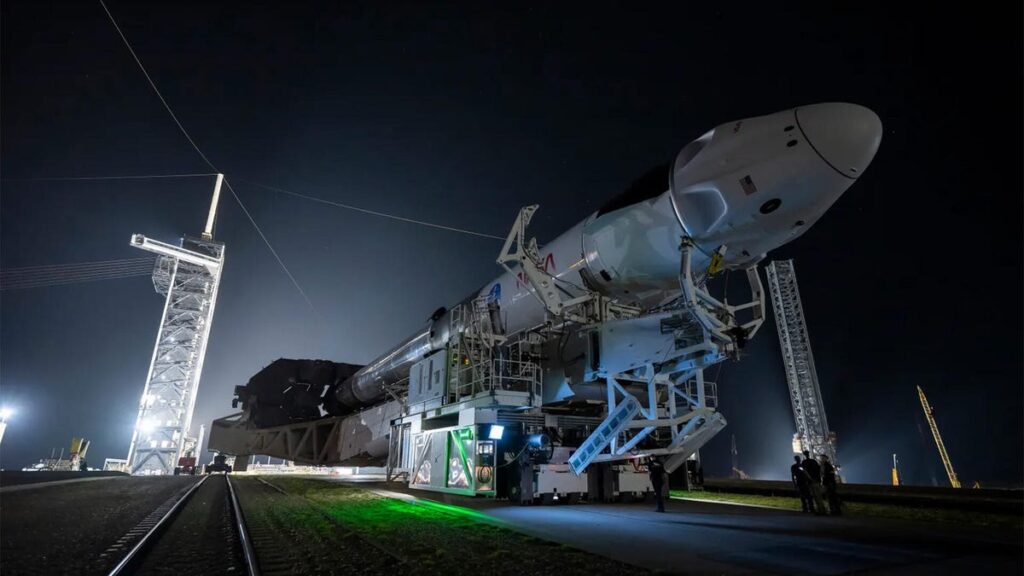 A night photo of the SpaceX Falcon 9 being transported
