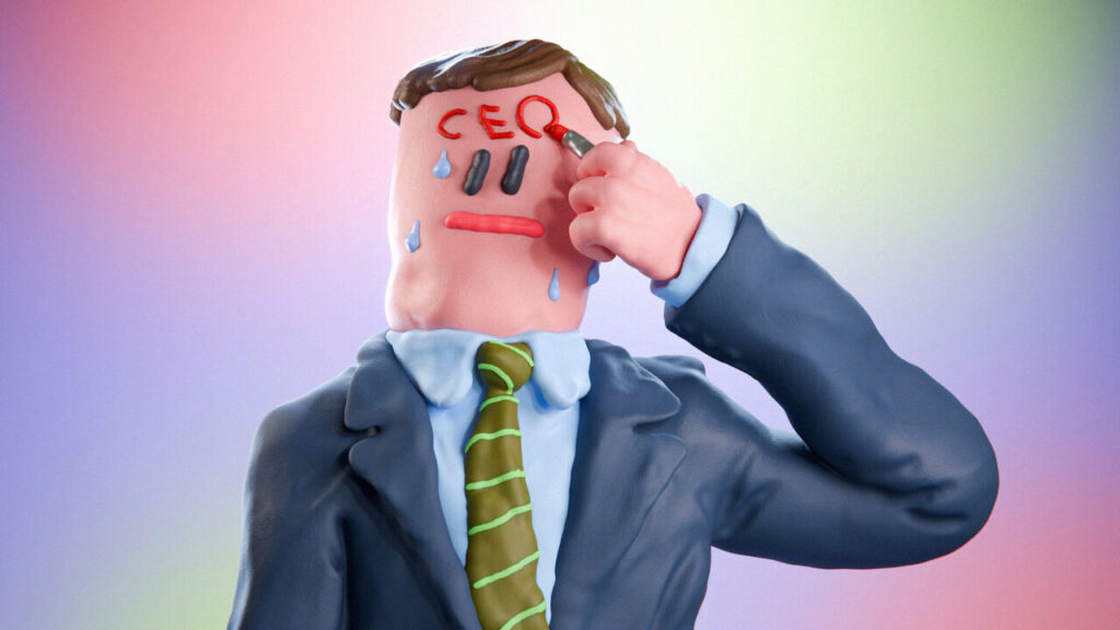 A suited man writing "CEO" on his forehead