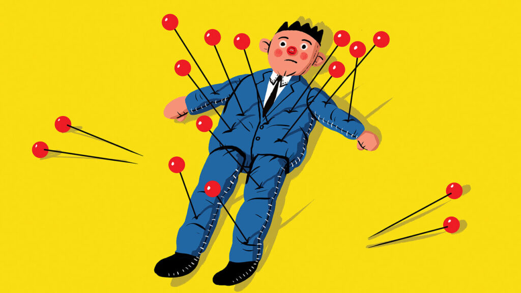 A doll with loads of red pins in it.