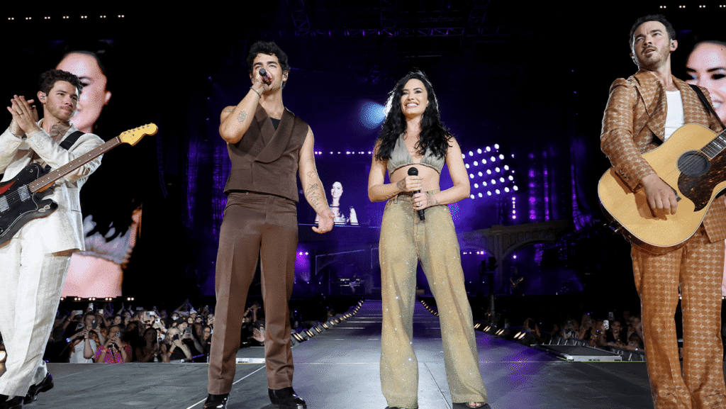 (L-R) Nick Jonas, Joe Jonas, Demi Lovato and Kevin Jonas perform onstage during the Jonas Brothers: JONAS20 Greetings From Your Hometown tour kick off at Met Life Stadium on Aug. 10, 2025.