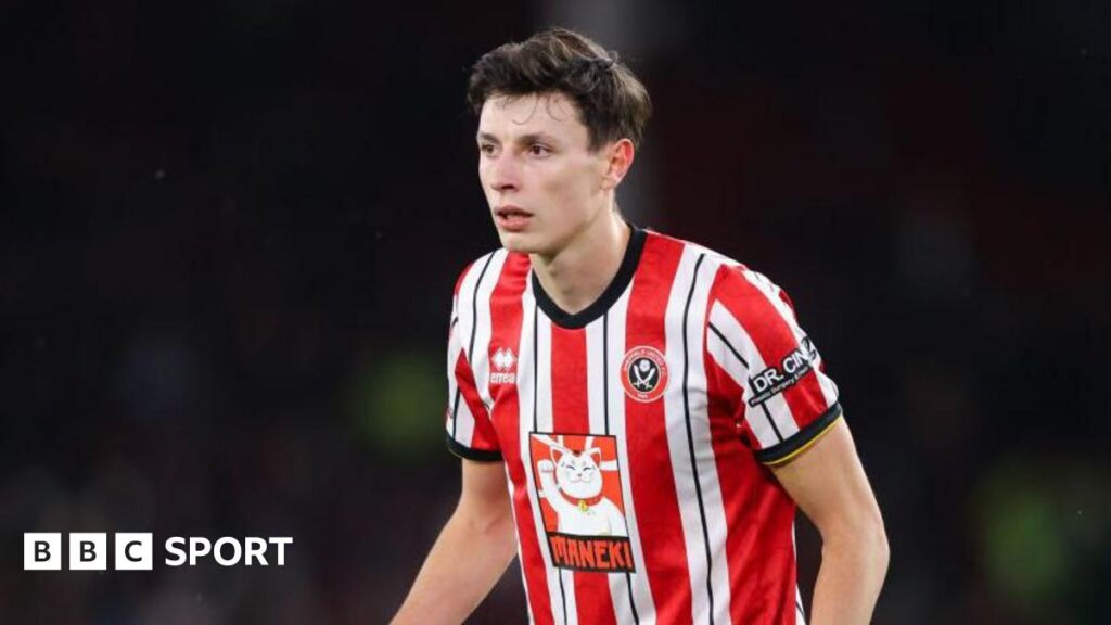 Anel Ahmedhodzic wearing a red and white Sheffield United shirt