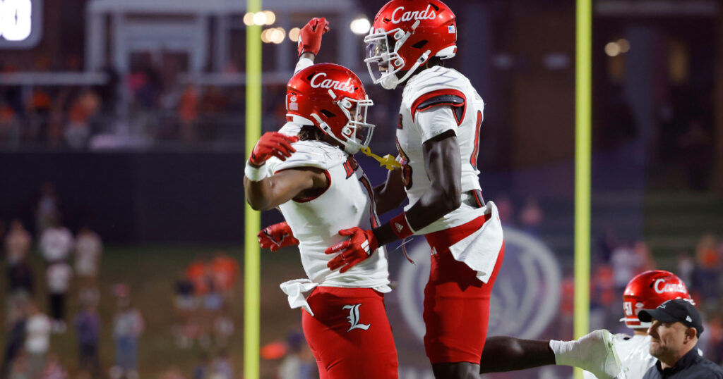 Oct 12, 2024; Charlottesville, Virginia, USA; Louisville Cardinals tight end Jamari Johnson (11) celebrates with Cardinals tight end Jaleel Skinner (88) after scoring the game winning touchdown against the Virginia Cavaliers during the second half at Scott Stadium. Mandatory Credit: Amber Searls-Imagn Images