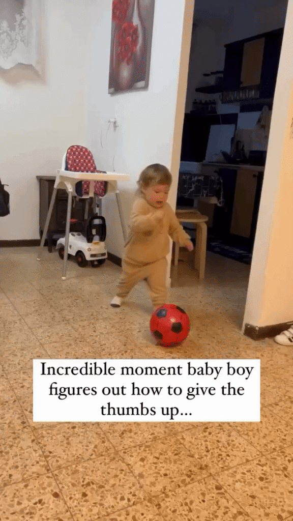 Boy discovers how to give a thumbs up.