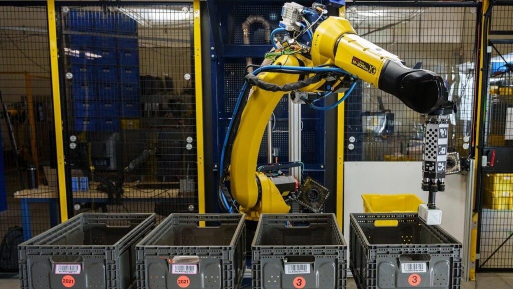 Robotic arm sorting items into four boxes