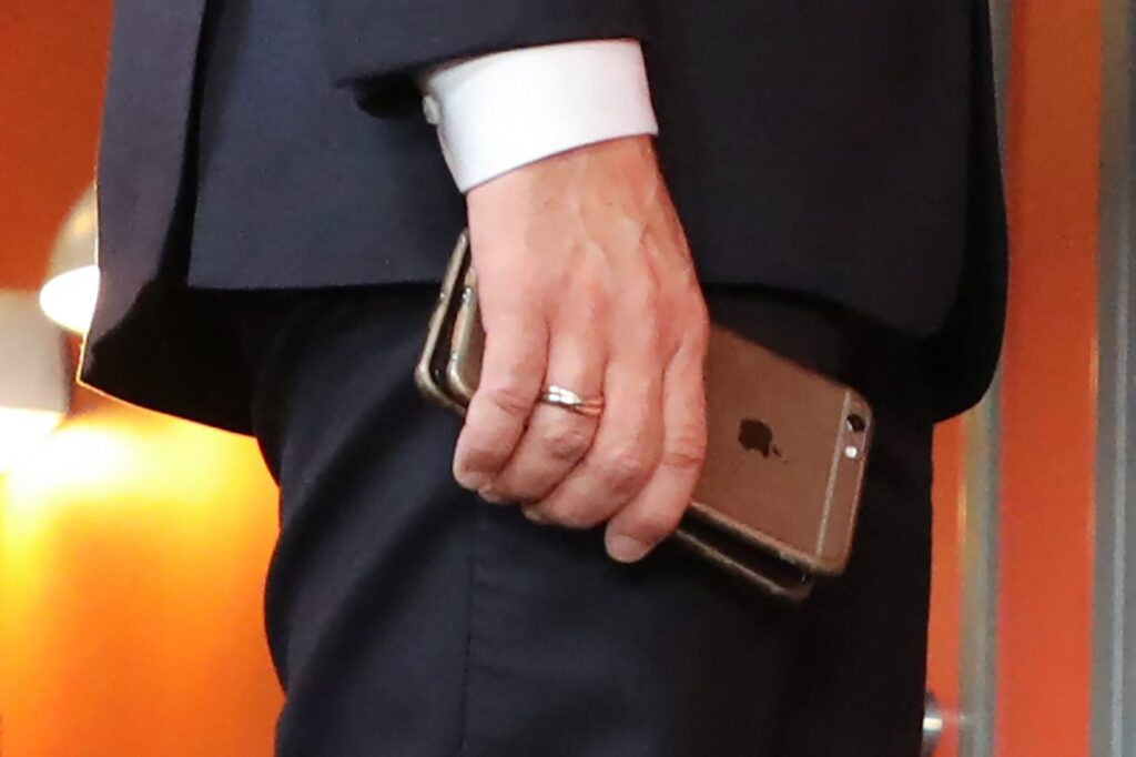 France says Apple notified victims of new spyware attacks France's President Emmanuel Macron holds his mobile phones while talking with Slovakia's Prime minister during the European Social Summit in Gothenburg, Sweden