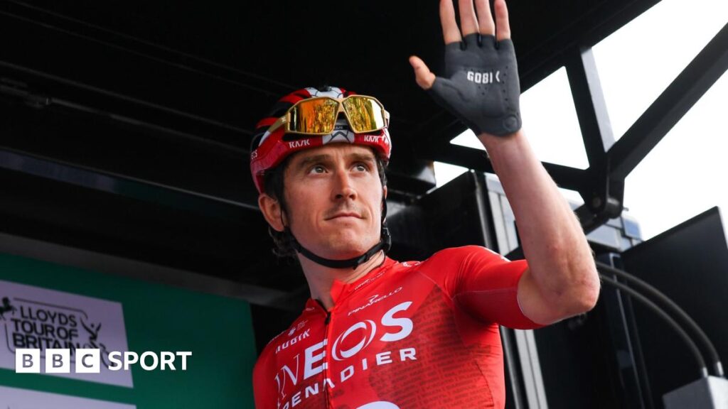 Geraint Thomas wears a red top and black shorts and he cycles past crowds of people