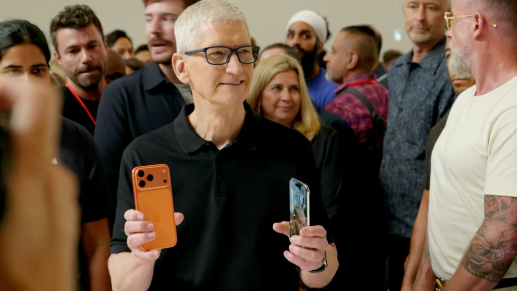 Tim Cook shows off orange iPhone 17 Pro to the press.