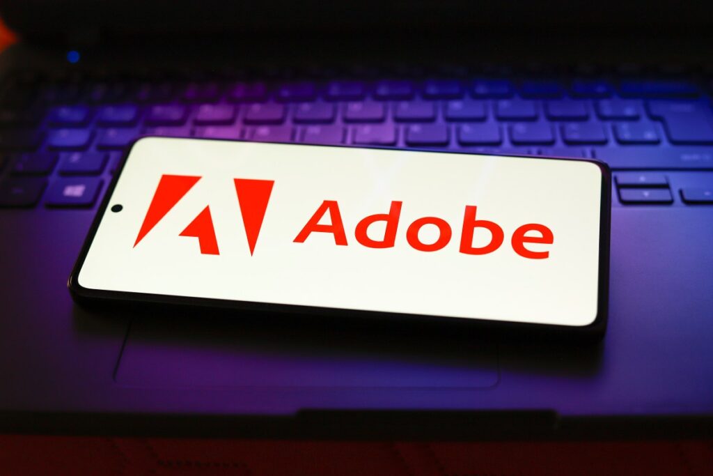 Adobe Firefly Image 5 brings support for layers, will let creators make custom models The Adobe Inc. logo displayed on a smartphone screen.