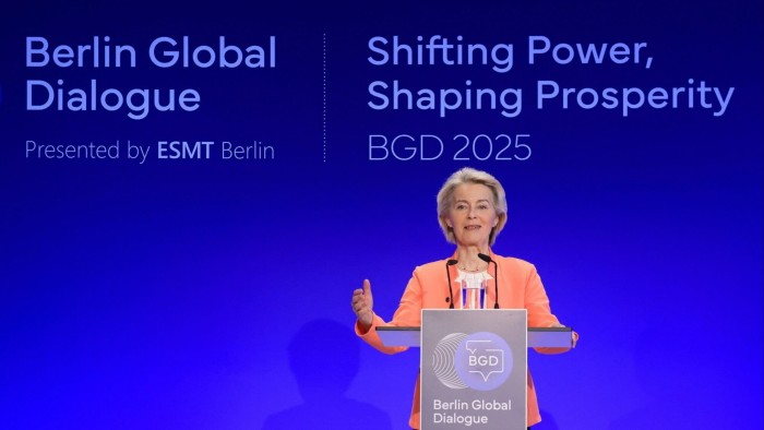 EU pressed to back critical minerals projects as China tightens grip Ursula von der Leyen speaks at a podium during the Berlin Global Dialogue, with event branding visible behind her.