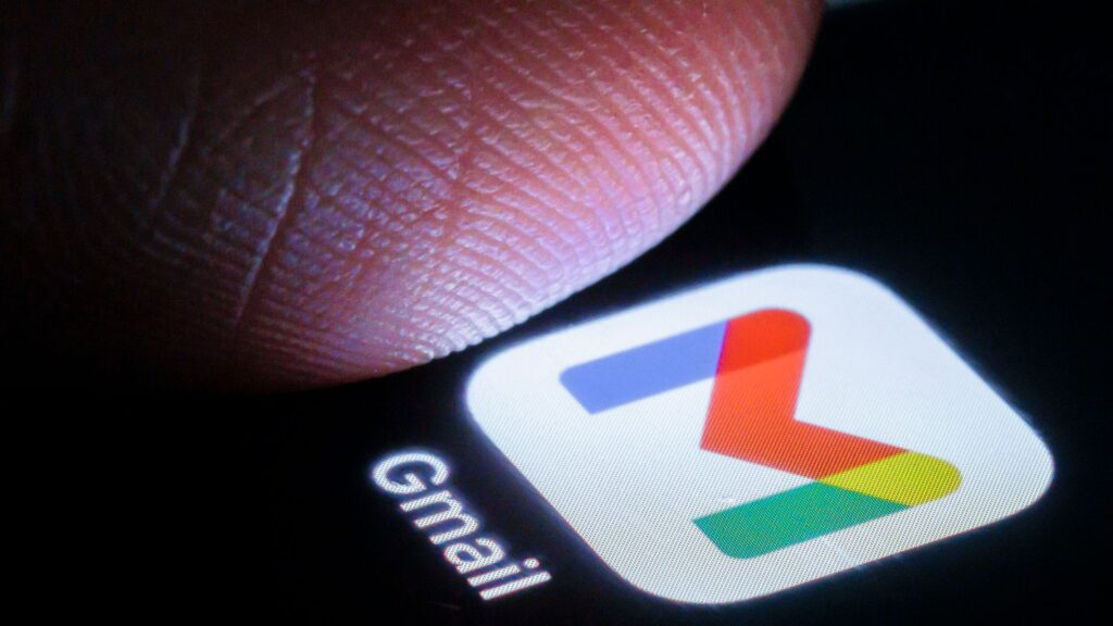 Gmail app on a phone with a thumb hovering above