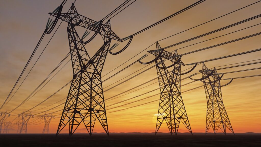 The silhouette of the high voltage power lines during sunset.