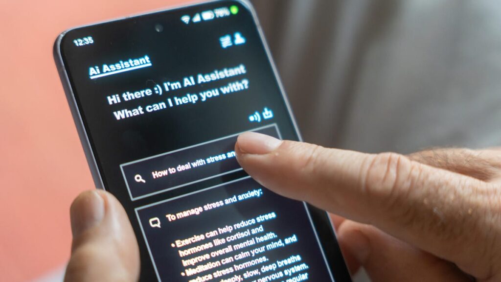 A person holds a phone and taps on an AI chatbot.