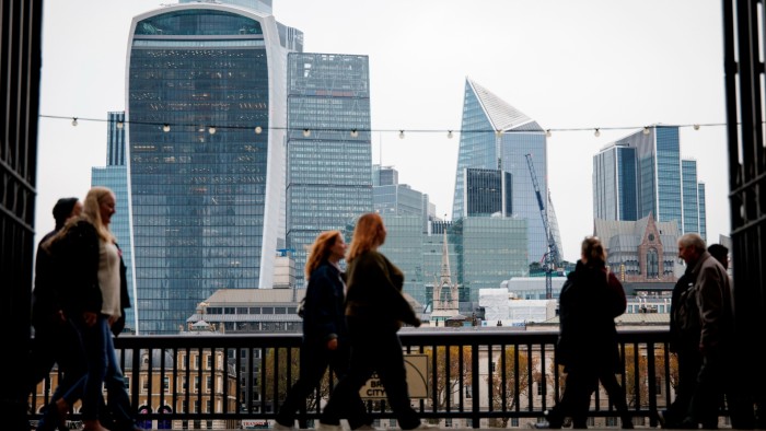 Tax raid on UK partnerships to be less aggressive than feared People walking along the South Bank with the City of London’s modern skyscrapers visible in the background.