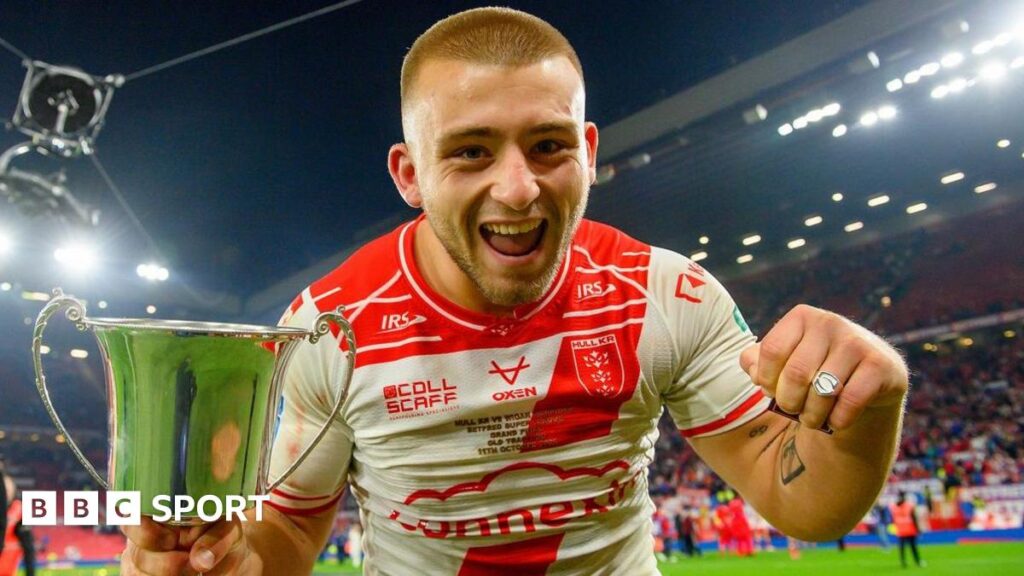 Hull KR's Mikey Lewis celebrates with the Rob Burrow Award trophy and his Grand Final winner's ring.