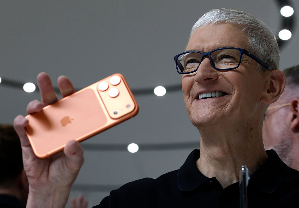The iPhone just had its best quarter ever Apple CEO Tim Cook holds up a new iPhone 17 Pro